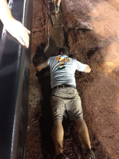 Head Groundskeeper Marty Wallace clears a drain Thursday night. Picture taken by season ticket holder Leigh Ann Browning.