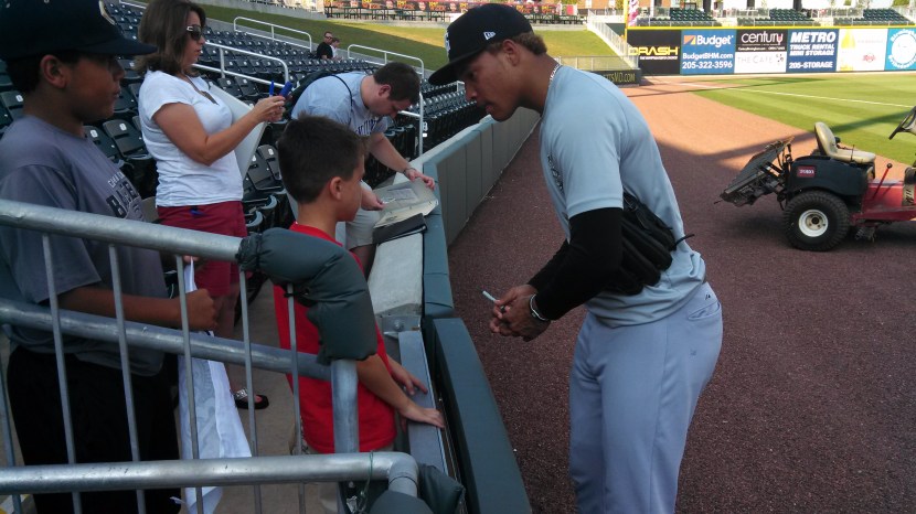 Taijuan Walker signs autographs for fans in Birmingham.