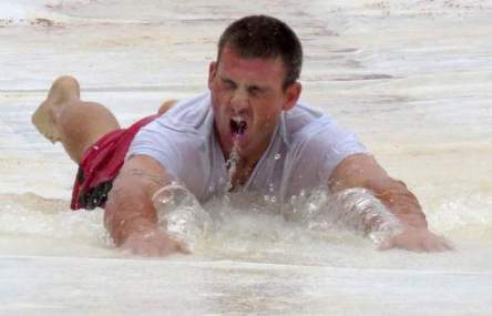 Pensacola's Devin Lohman slides on the tarp on Friday after game was cancelled. (Bruce Graner)